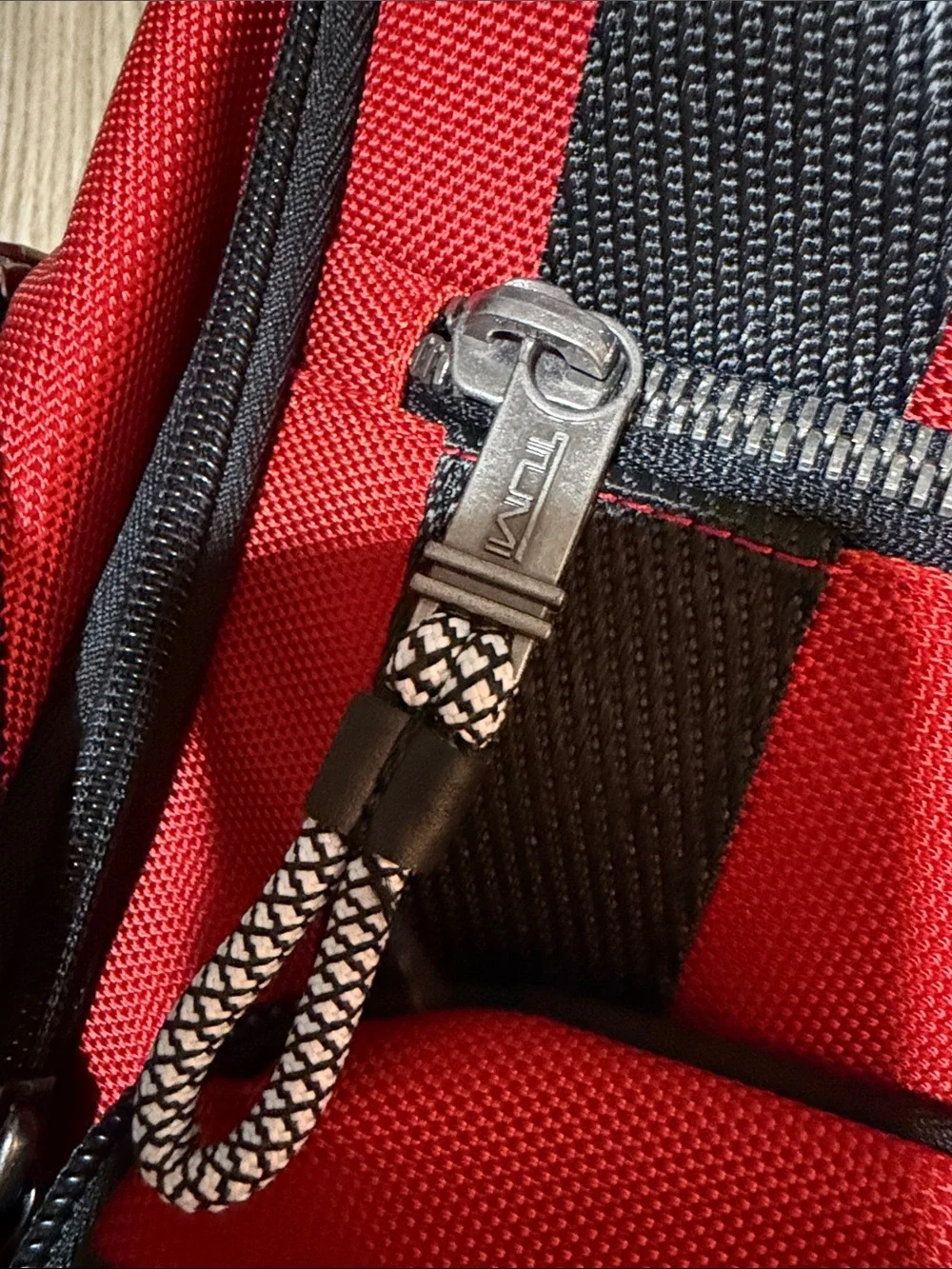Tumi Red and Black Men/Women’s Backpack with Multiple Front Pockets